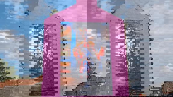 The Rachel Maclean mural of Billy Connolly (The Big Yin) in Viking costume, painted on a bright pink building wall.