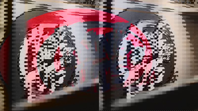 A close-up shot of the King Tut's Wah Wah Hut logo, a vibrant red and white sign for the famous Glasgow live music venue.