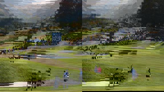 pectators gathered around the fairway at Gleneagles golf course during a professional tournament, with rolling hills and scenic countryside in the background.