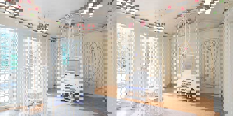 A clean, bright room designed in the style of Charles Rennie Mackintosh. The space features white furniture with delicate art nouveau curves and purple accents.