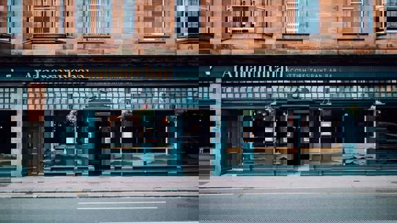 The street-level exterior of Ardnamurchan Scottish Restaurant & Bar, with a dark teal storefront and gold lettering on a sandstone building.