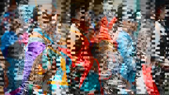 A group of people smiling and laughing at a parade.