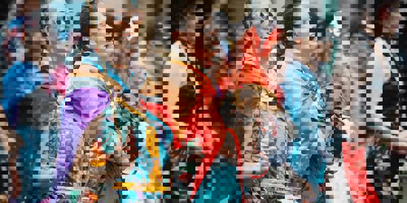 A group of people smiling and laughing at a parade.