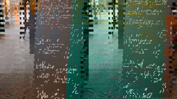 Chalkboard menu listing Thursday’s specials like grilled sardines and lamb heart.