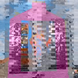 Bright pink building with a large mural of Billy Connolly in a fantastical, colourful costume with a horned helmet.