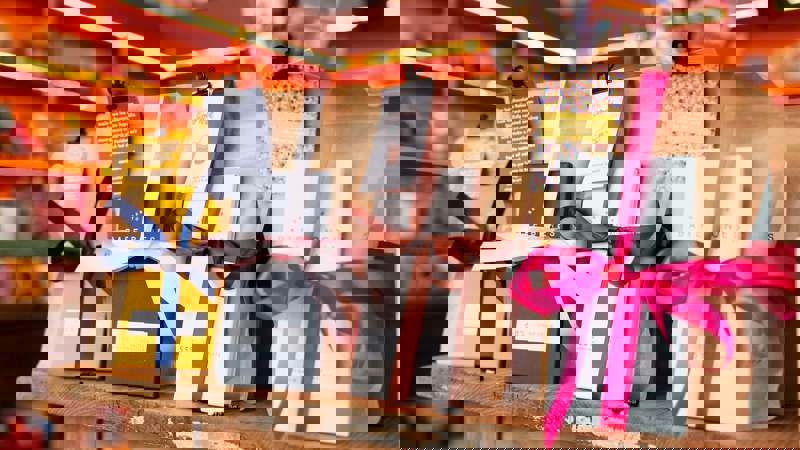 A display of chocolate bars from the brand Bare Bones, packaged with colourful ribbons.