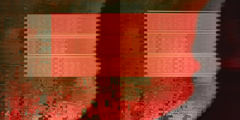 A dimly lit, red push-letter sign behind the bar at Sub Club reads "SUBCULTURE, DJ MASDA, HARRI & DOMENIC".