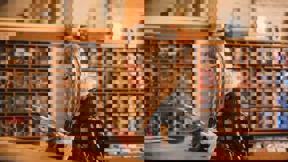 A person in a record store looking at a vinyl record.