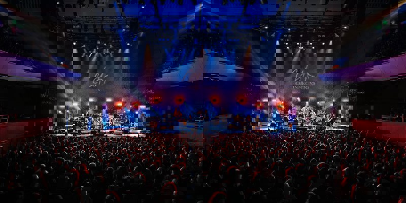 Audience seated in Glasgow Royal Concert Hall watching a Celtic Connections performance on a brightly lit stage.