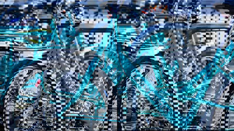 A close-up shot of several turquoise-coloured bicycles from a company called "Glasgow Bike Tours."