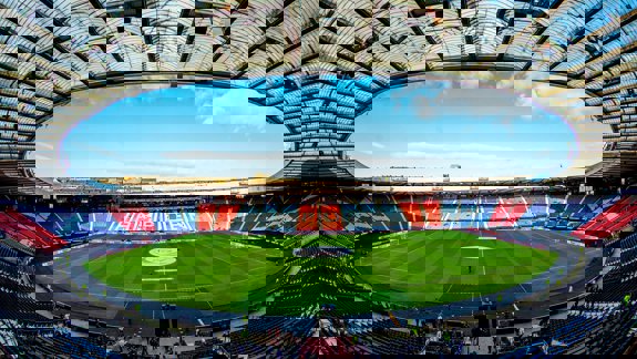 An overview of a large stadium with a blue sky overhead.