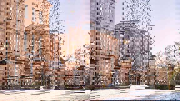 Elegant sandstone townhouses at Park Circus in Glasgow on a bright winter day with light snow.