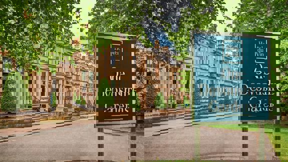 Exterior of Hotel du Vin, One Devonshire Gardens, with elegant Victorian townhouses, neatly trimmed topiary, and a sign in the foreground.