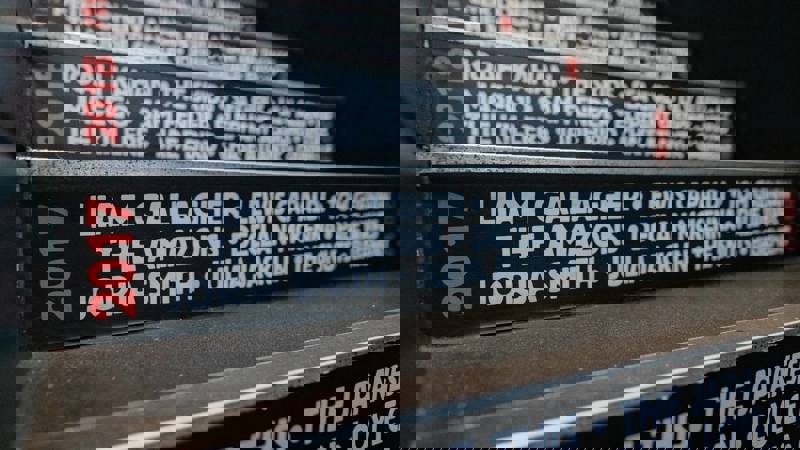 A close-up view of a staircase with the names of musicians who performed there, including Liam Gallagher and Lewis Capaldi.