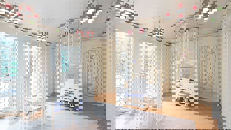 A white-painted room with furniture and light fixtures in the Mackintosh style, including a piano and a small dining table.